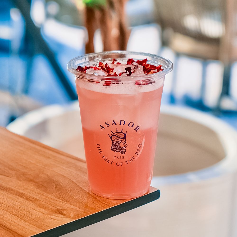 Iced Pink Flower Rose and Bubblegum Drink in Plastic Cup at Asador Coffee El Jadida