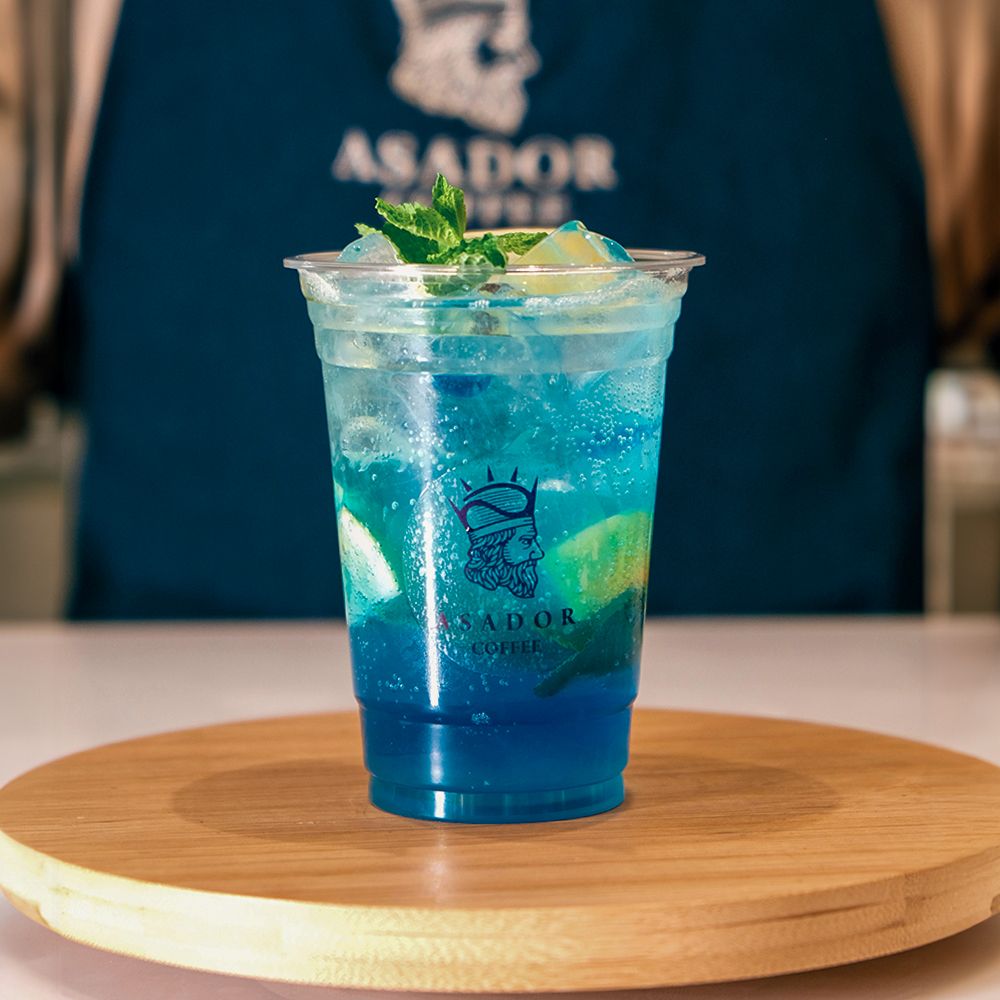 Iced Blue Curacao Mocktail with Lemon and Mint in Plastic Cup at Asador Coffee El Jadida