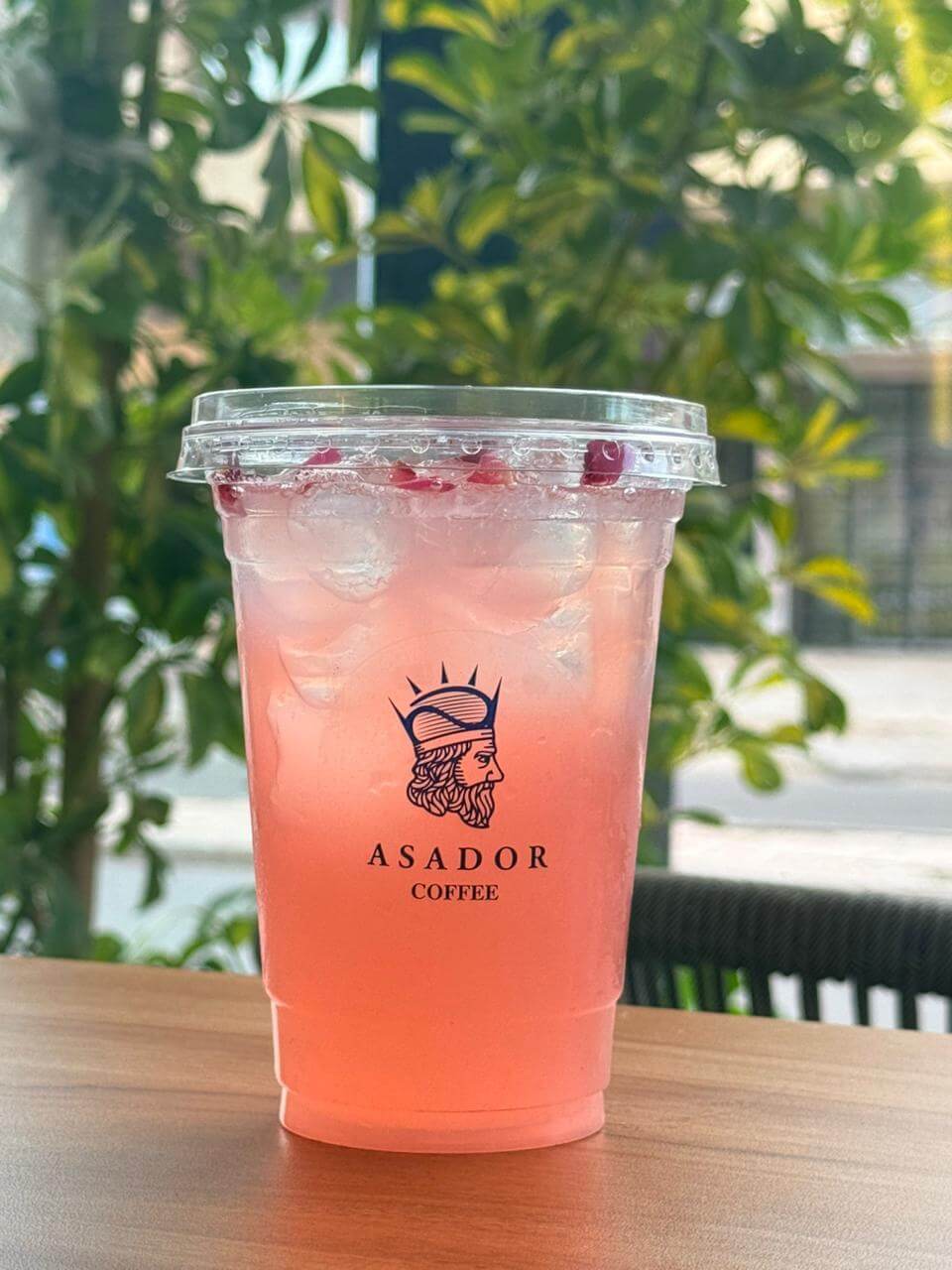 Iced Pink Flower Rose and Bubblegum Drink in Plastic Cup at Asador Coffee El Jadida