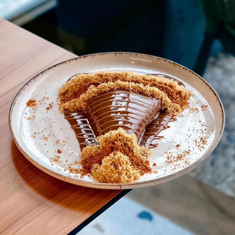 Fusion Crepe Kunafa Lotus with Cream Cheese Filling and Biscoff Crumbs at Asador Coffee El Jadida