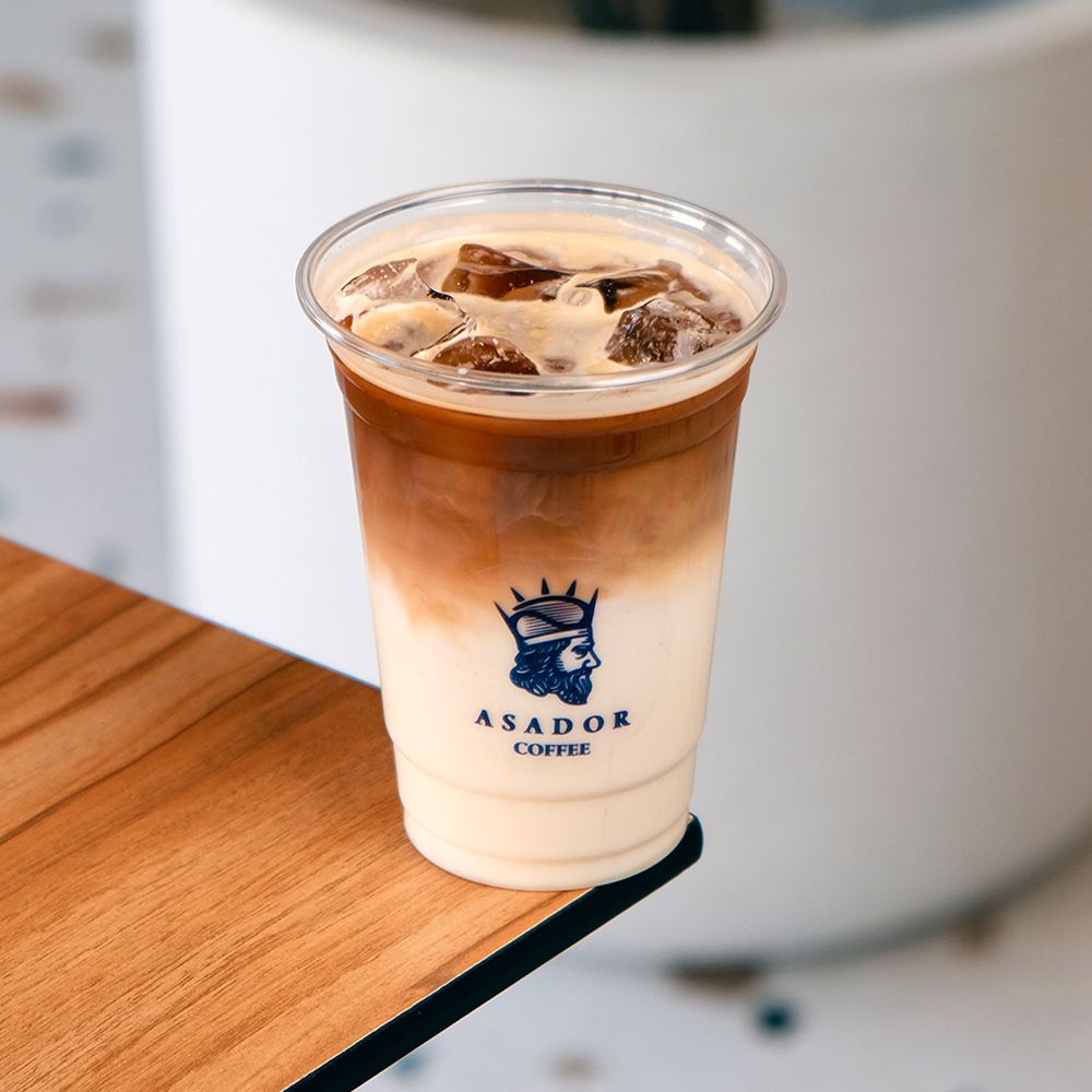 Layered Iced Spanish Latte with Condensed Milk in Plastic Cup at Asador Coffee El Jadida