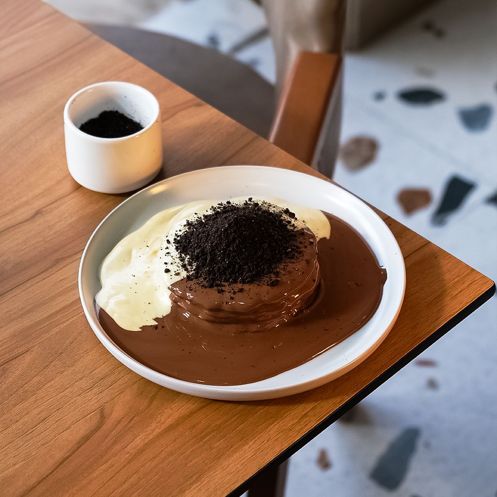 Fluffy Ferrero Pancakes with Half Milk Chocolate and Half White Chocolate Topping at Asador Coffee El Jadida