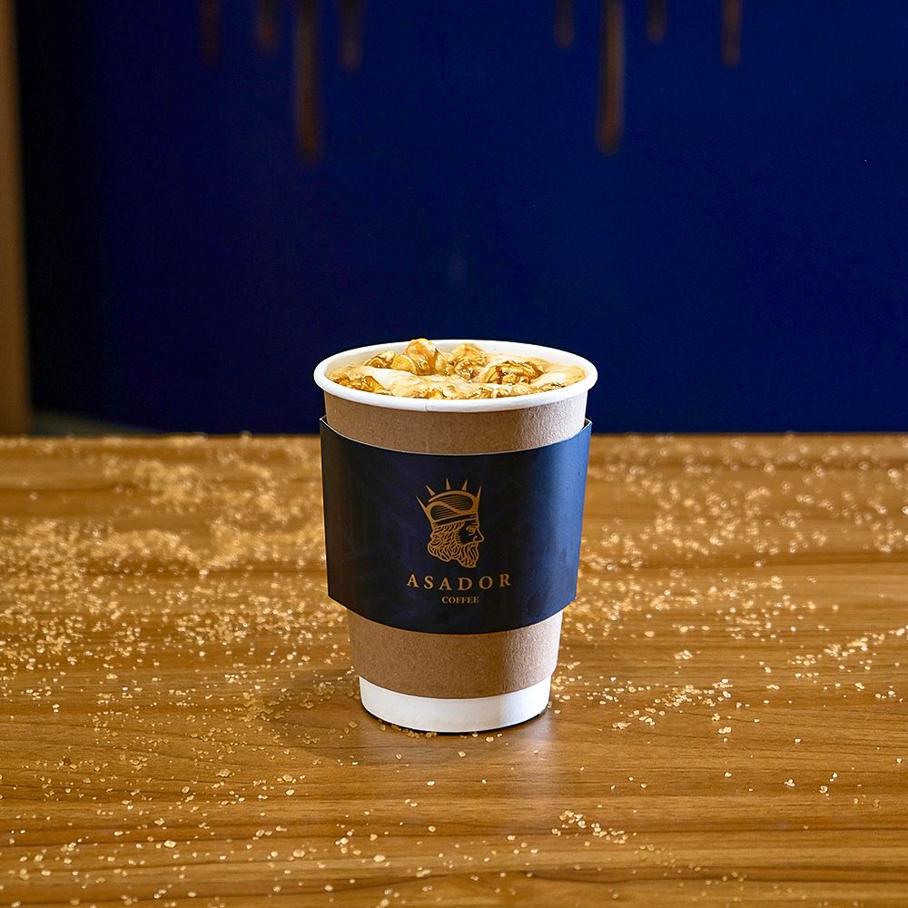 Hot Popcorn Latte with Caramel Popcorn Topping in Takeaway Cup at Asador Coffee El Jadida