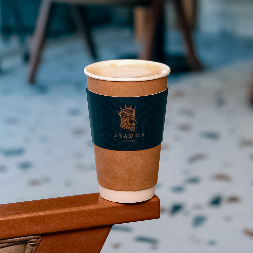 Hot Salted Caramel Latte with Latte Art on Wooden Coaster at Asador Coffee El Jadida