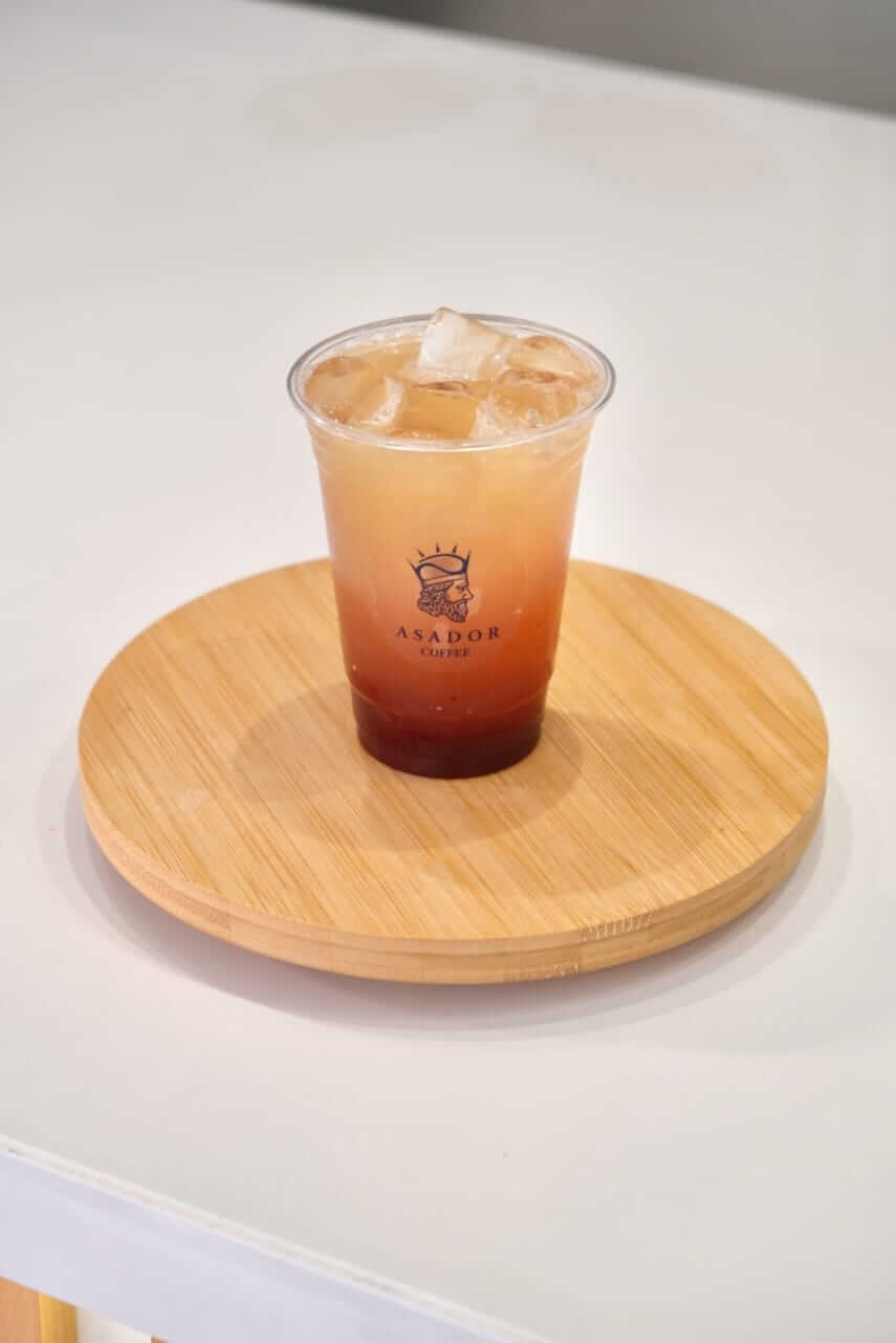 Iced Summer Vibe Mocktail with Mango Strawberry and Soda in Plastic Cup at Asador Coffee El Jadida