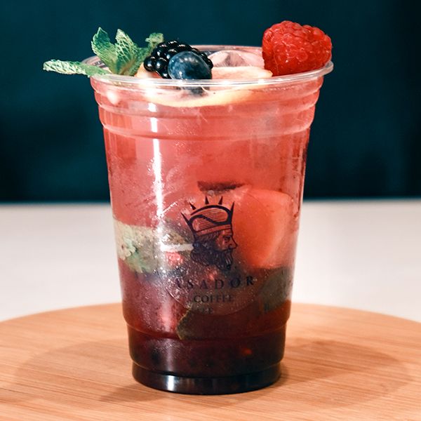 Iced Mixed Berry Mojito with Blueberries Raspberries and Mint in Plastic Cup at Asador Coffee El Jadida