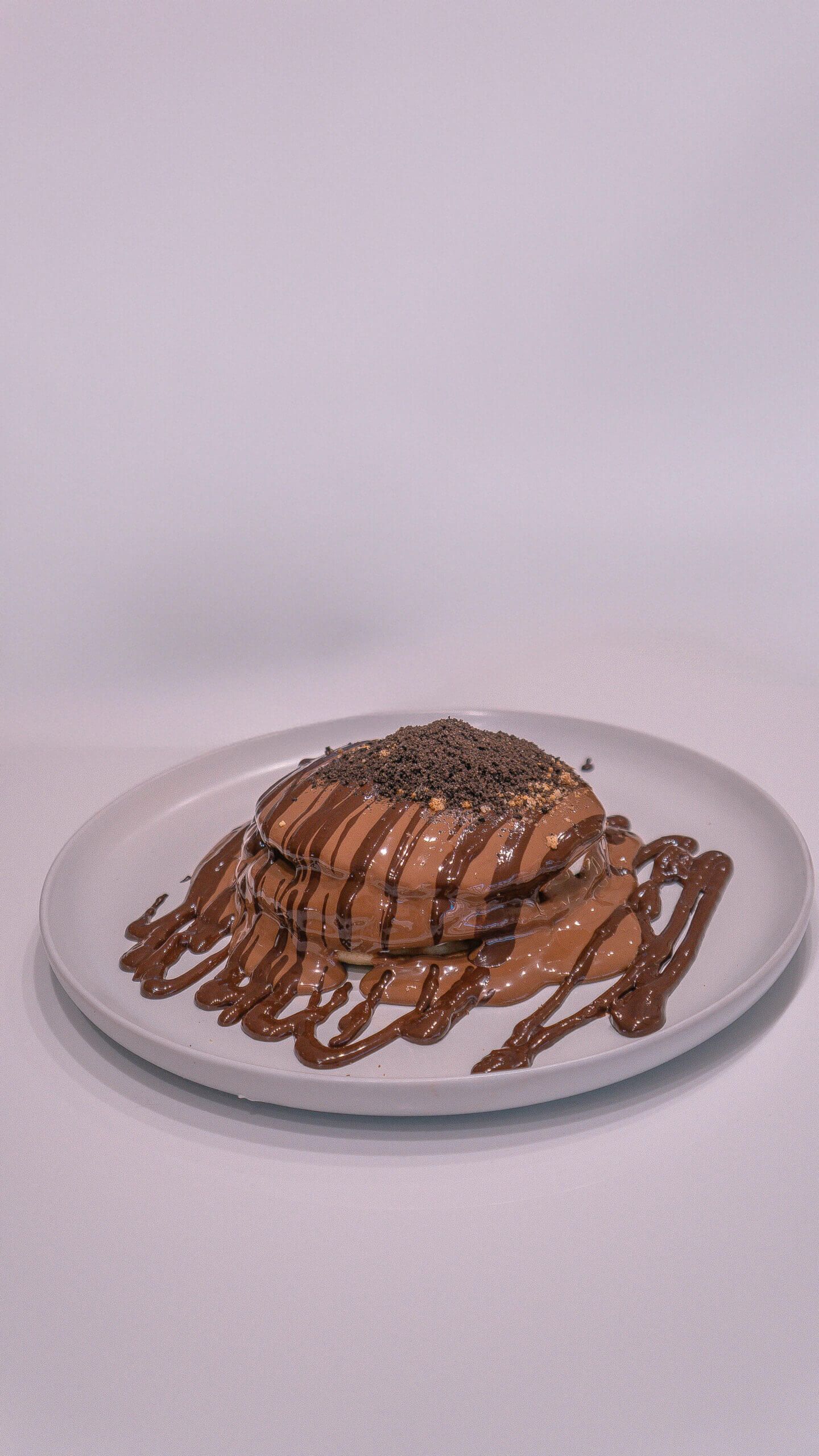 Stack of Fluffy Cookie Pancakes with Milk Chocolate and Cream Cheese Filling at Asador Coffee El Jadida