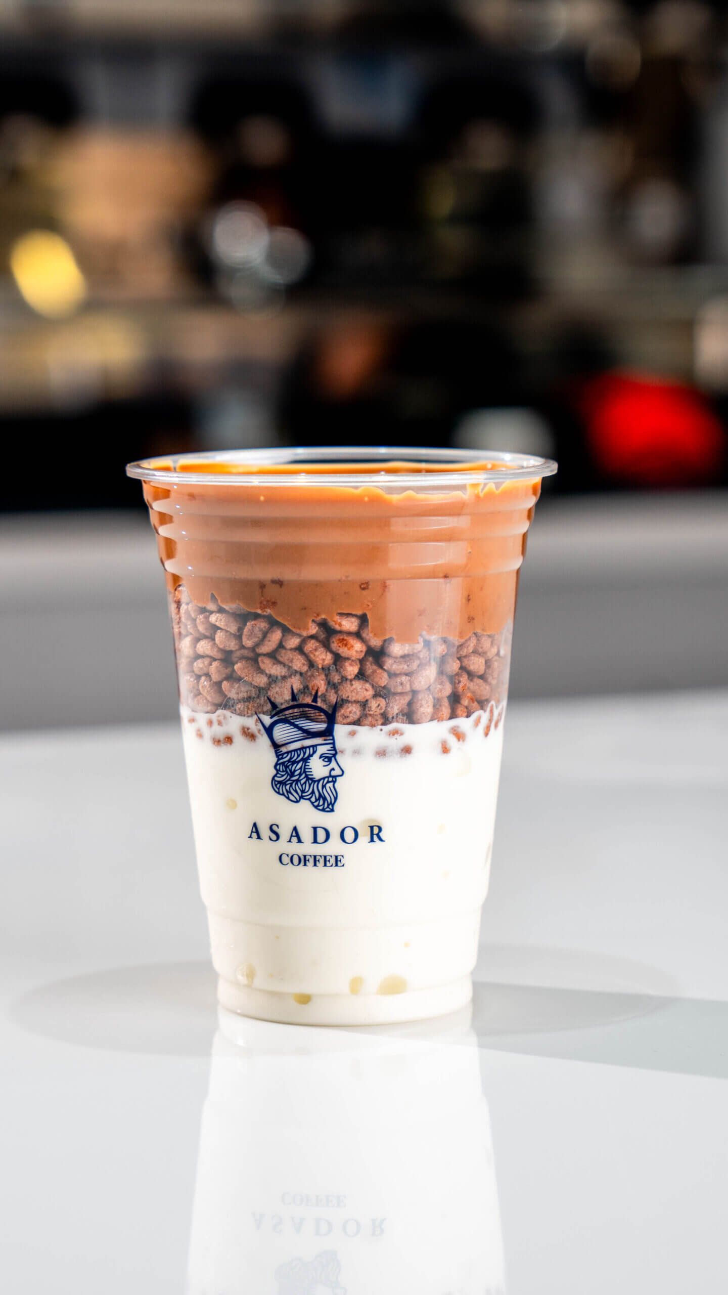 Milk Chocolate Ice Cream Drink with Layer of Crispy Rice in Plastic Cup at Asador Coffee El Jadida