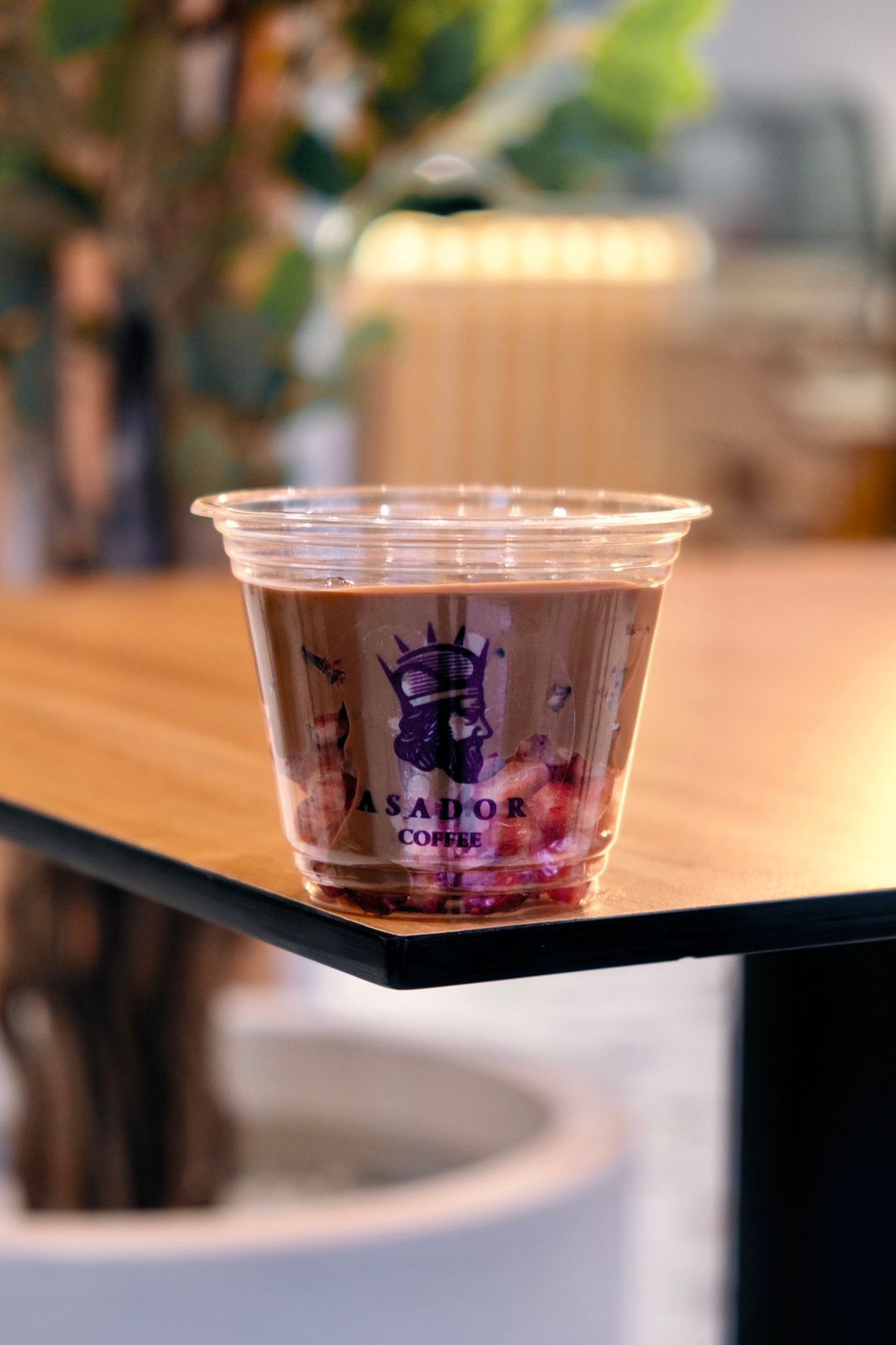 Iced Chocolate Drink with Red Grenadine Layer in Plastic Cup at Asador Coffee El Jadida