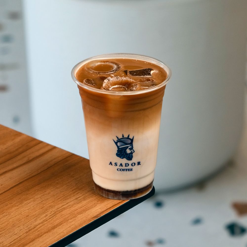 Iced Honey Pumpkin Spice Latte with Cinnamon Sticks in Plastic Cup at Asador Coffee El Jadida