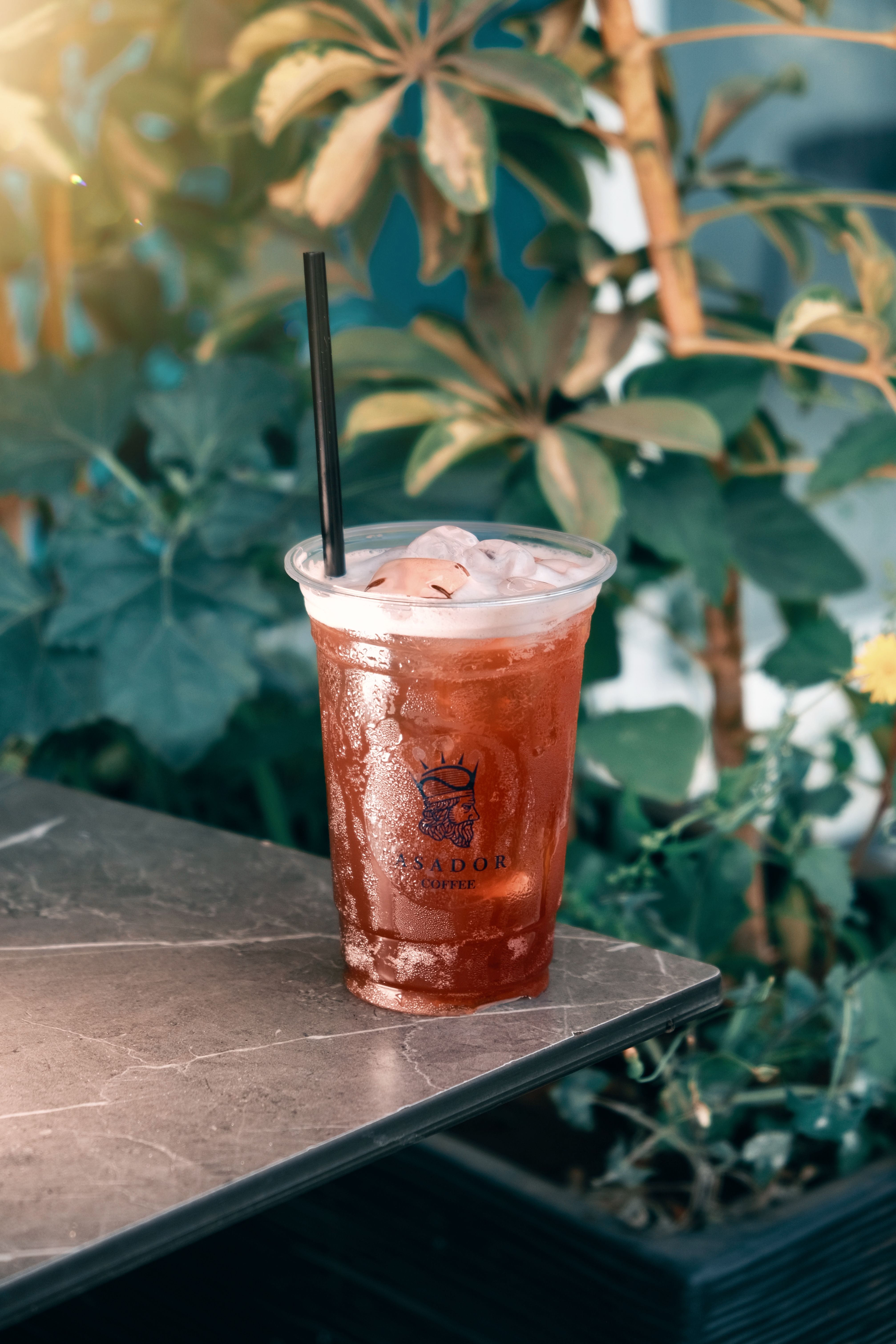 Iced Berry Tea Infusion with Fresh Mint and Mixed Berries in Plastic Cup at Asador Coffee El Jadida