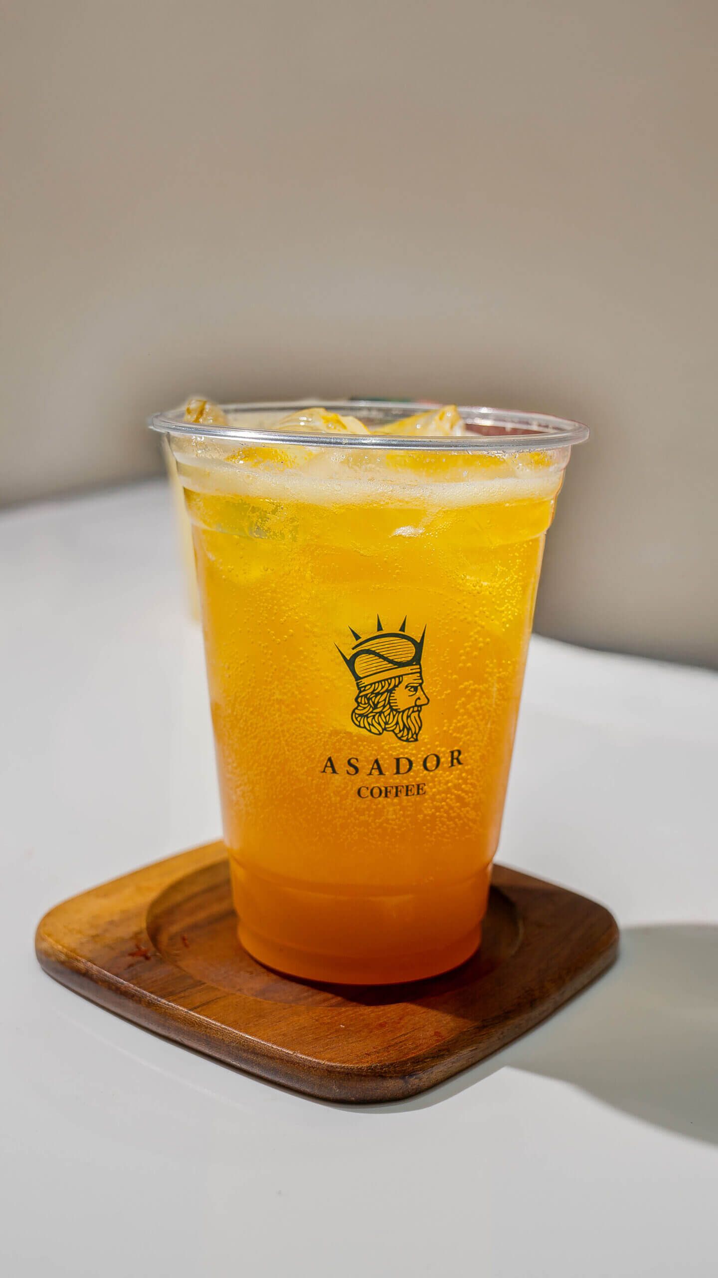 Iced Tropical Lemonade with Passion Fruit Peach and Coconut in Plastic Cup at Asador Coffee El Jadida