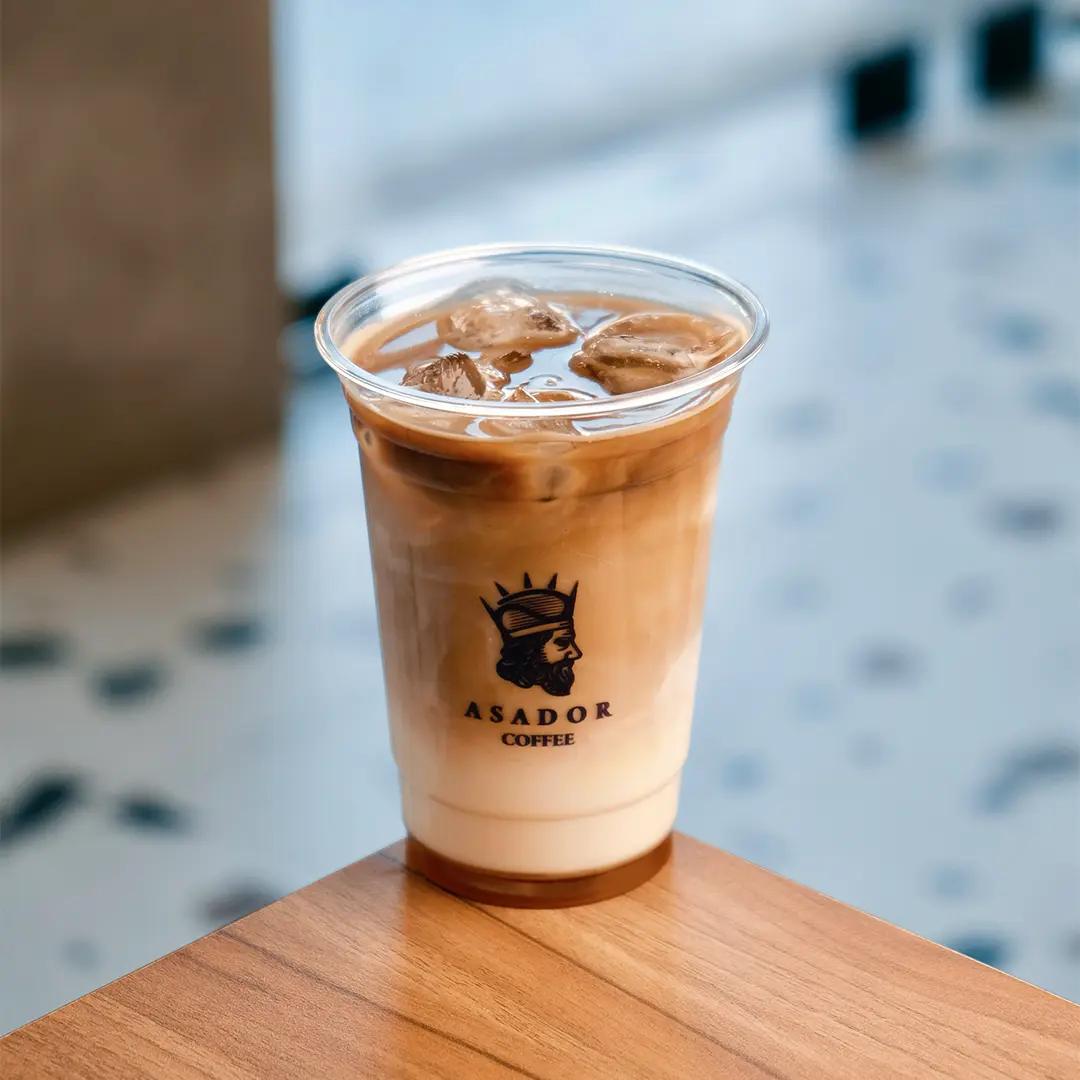 Iced Salted Caramel Latte with Caramel Drizzle in Plastic Cup at Asador Coffee El Jadida
