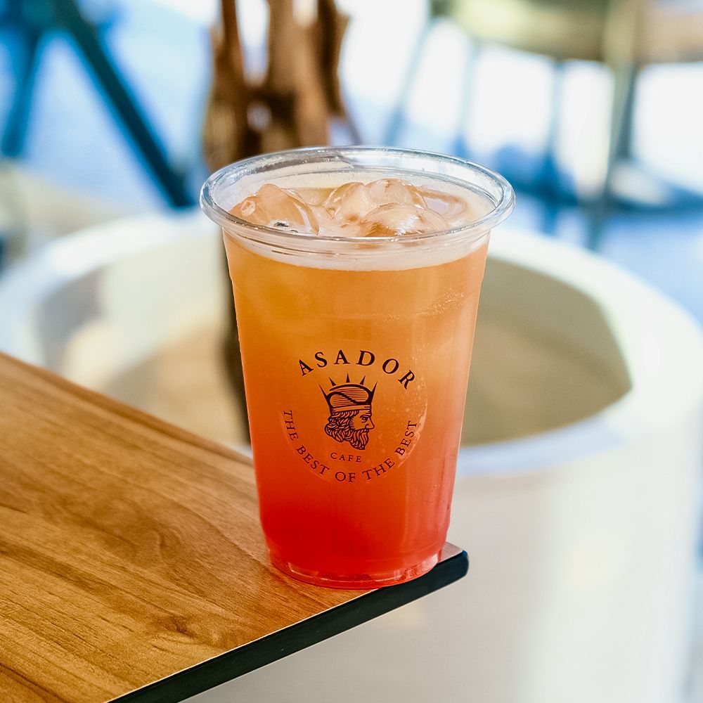 Iced Summer Vibe Mocktail with Mango Strawberry and Soda in Plastic Cup at Asador Coffee El Jadida