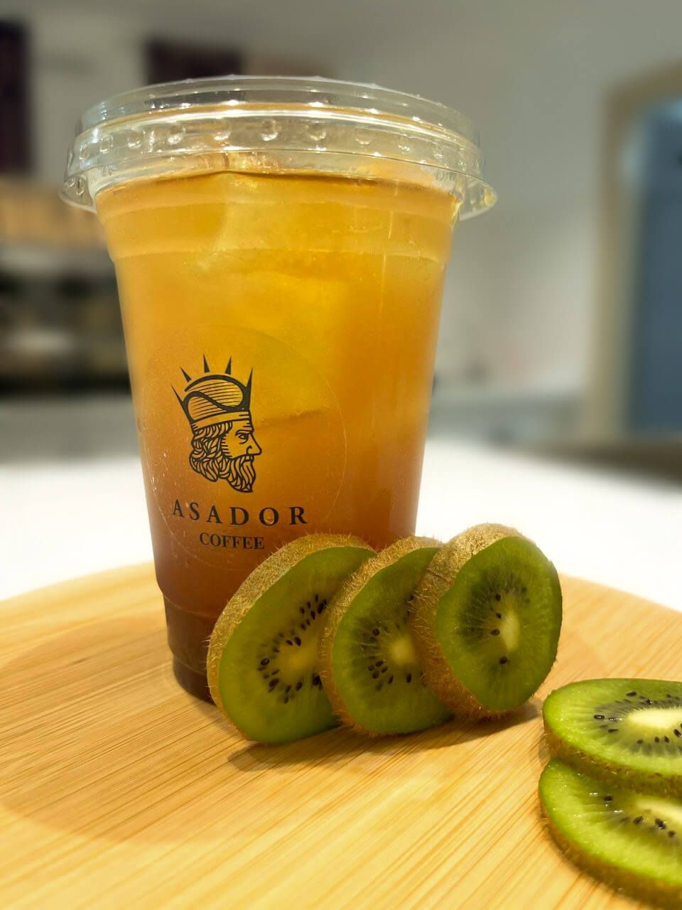 Iced Cherry Kiwi Energy Drink with Fresh Kiwi Slices in Plastic Cup at Asador Coffee El Jadida