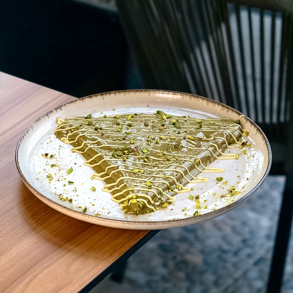 Folded Crepe Pistachio with Rich Green Pistachio Sauce and Crushed Nuts at Asador Coffee El Jadida