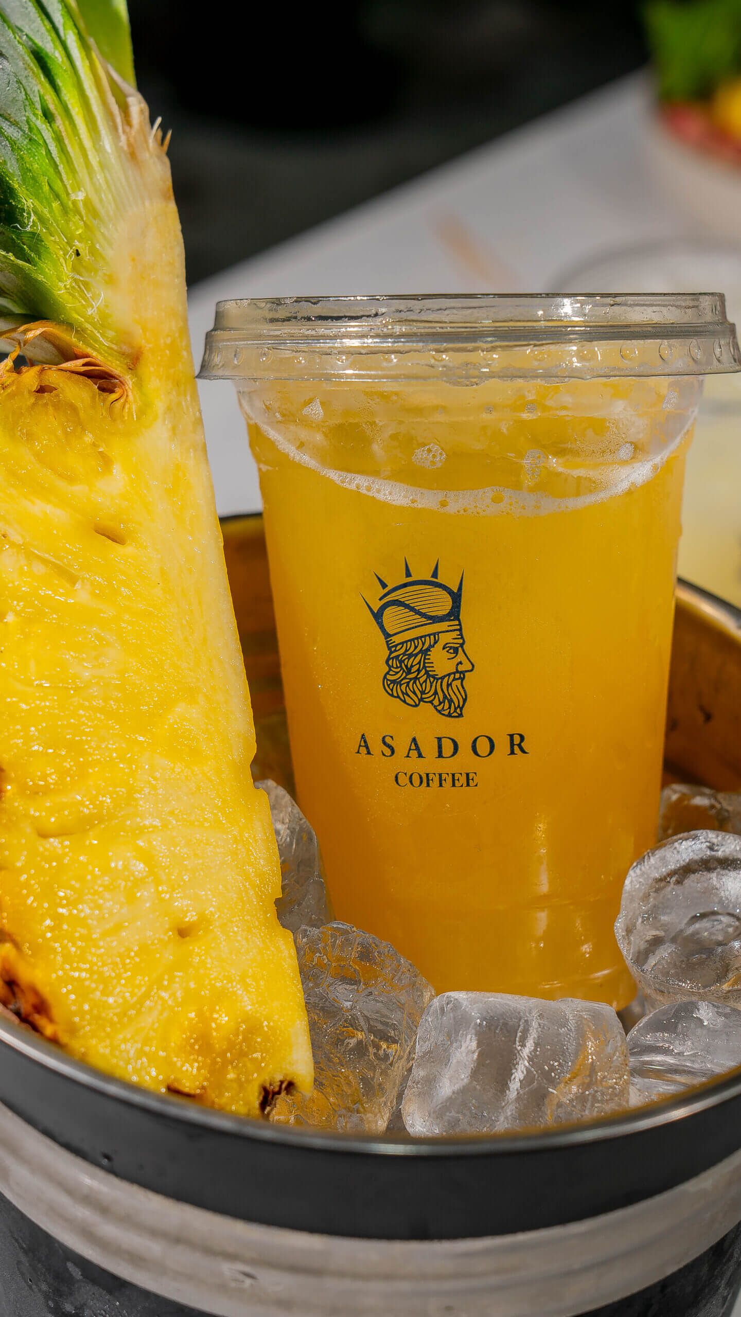 Iced Pavilion Energy Drink with Pineapple and Coconut and Fresh Pineapple Wedge at Asador Coffee El Jadida