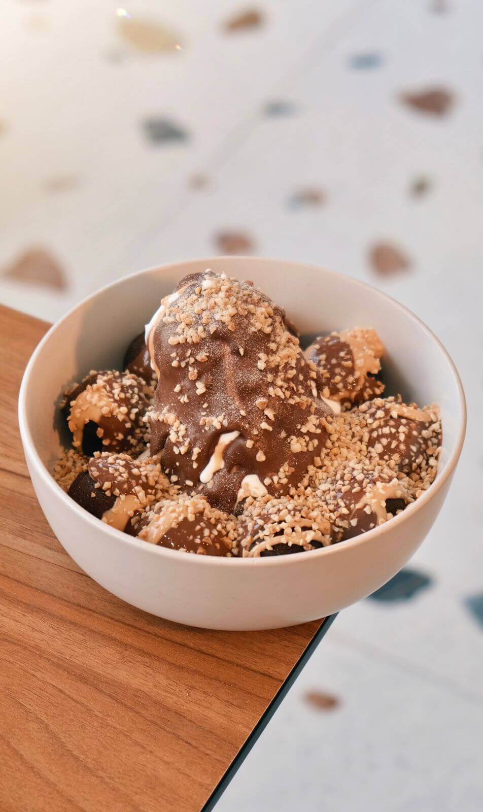 Peanut Butter Chocolate Cake Bombs Bowl with Ice Cream and Almonds at Asador Coffee El Jadida