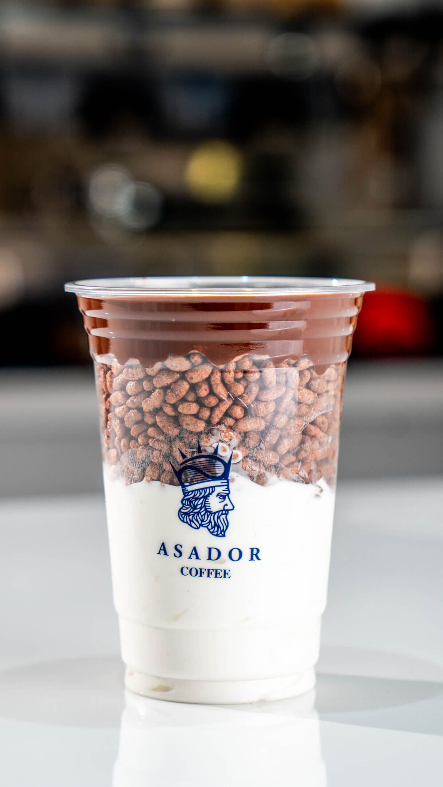 Dark Chocolate Ice Cream Drink with Layer of Crispy Rice in Plastic Cup at Asador Coffee El Jadida