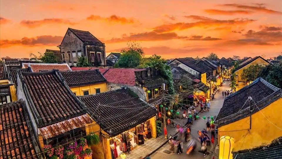 Moss-covered yin-yang tiled roofs of traditional houses in Hoi An Ancient Town