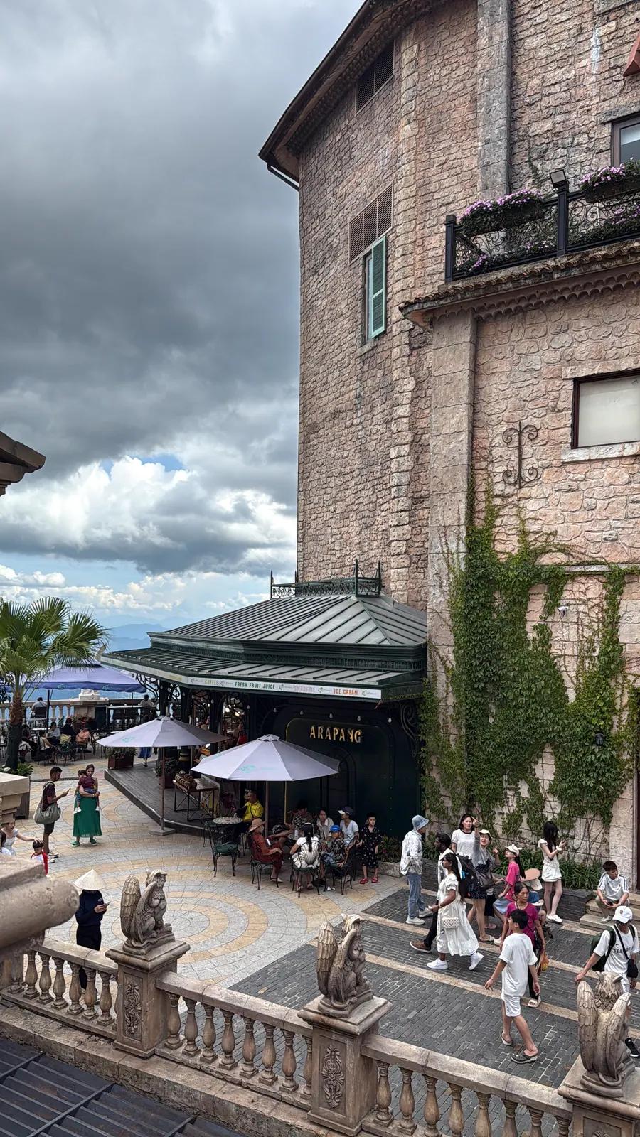 Stone buildings and a café terrace in the French Village at Ba Na Hills