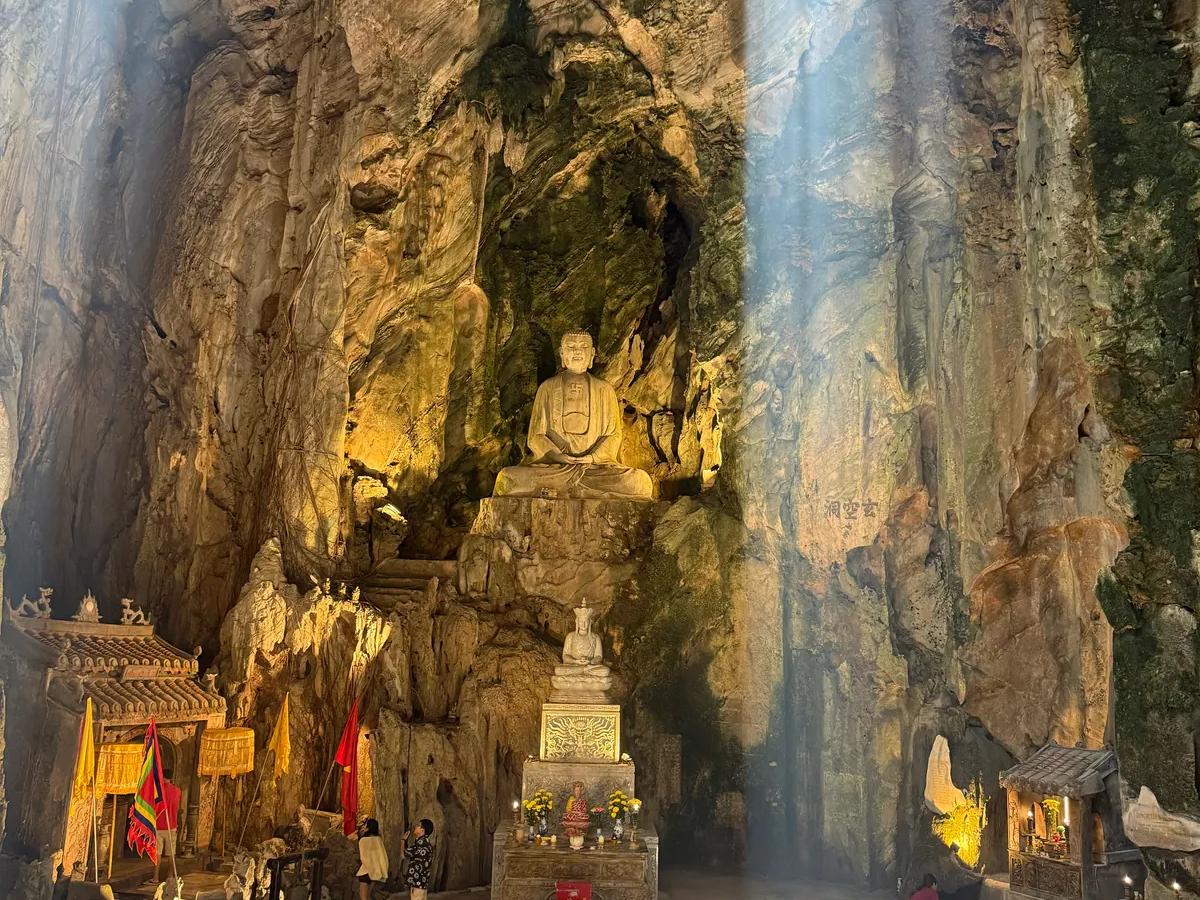 Daylight falling through the roof of Huyen Khong cave onto the shrine below