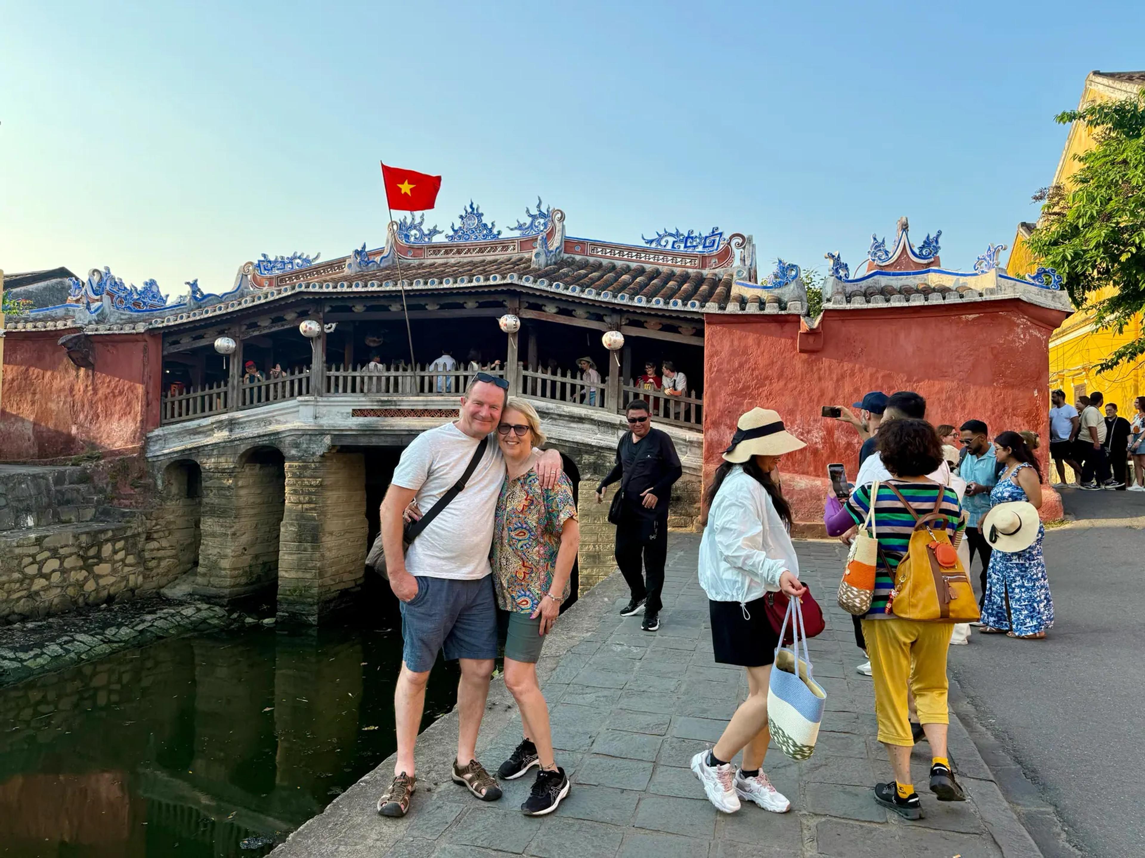Guests crossing the Japanese Covered Bridge in Hoi An Ancient Town