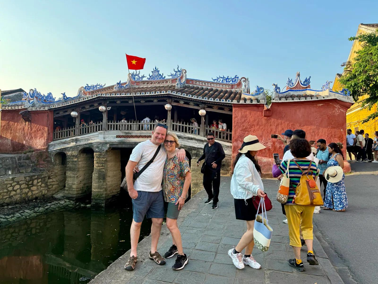 Guests crossing the Japanese Covered Bridge in Hoi An Ancient Town
