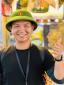 Toàn (Tom), licensed local guide in Hoi An, smiling with a thumbs up in a green Vietnamese pith helmet