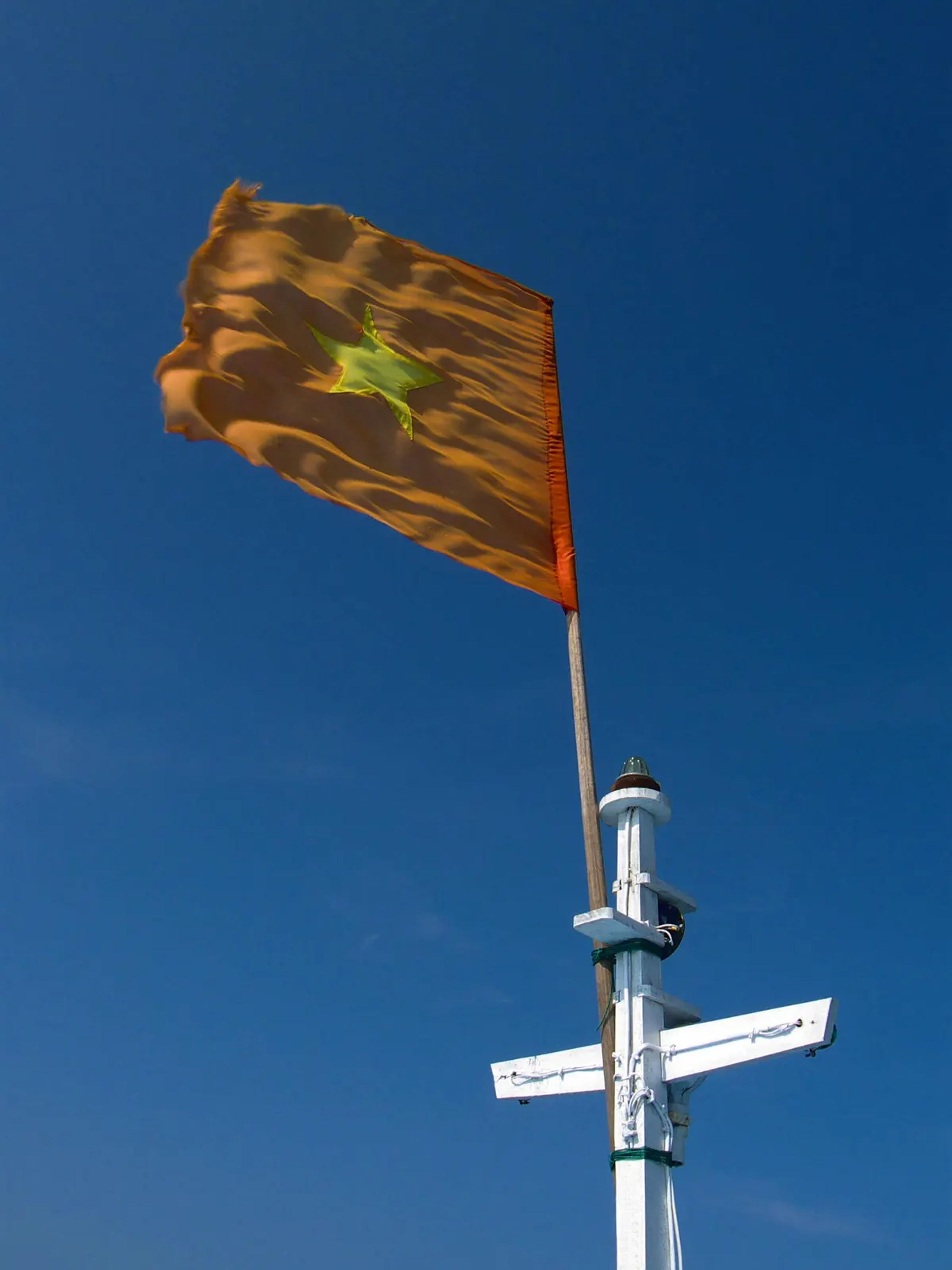 Vietnamese flag flying from a boat mast on the crossing to Cu Lao Cham