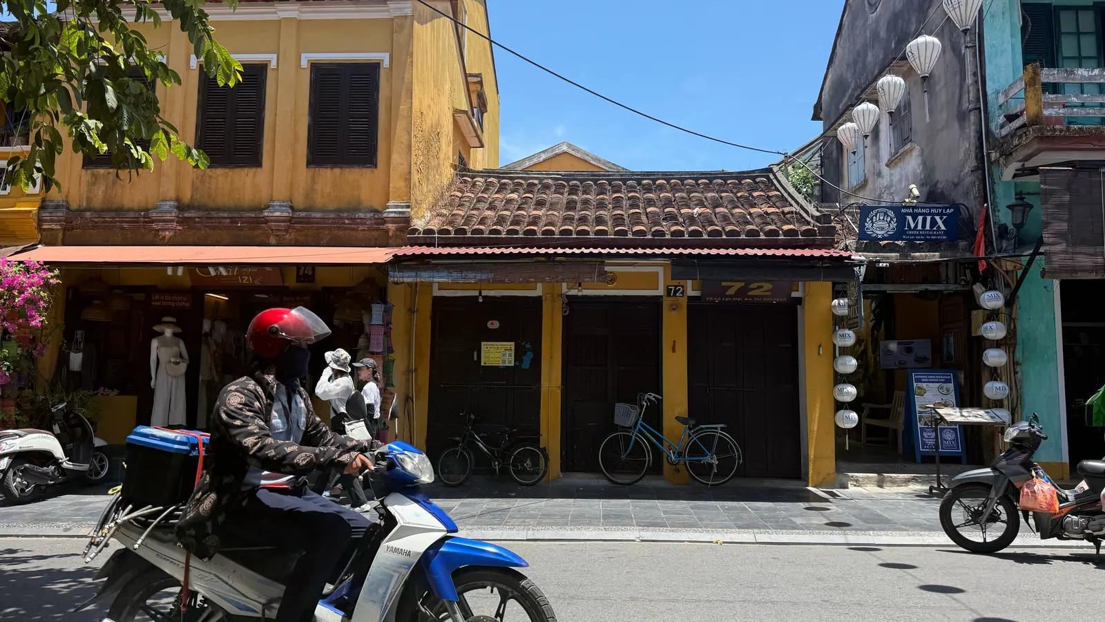Historic old street with traditional houses and local life in Hoi An