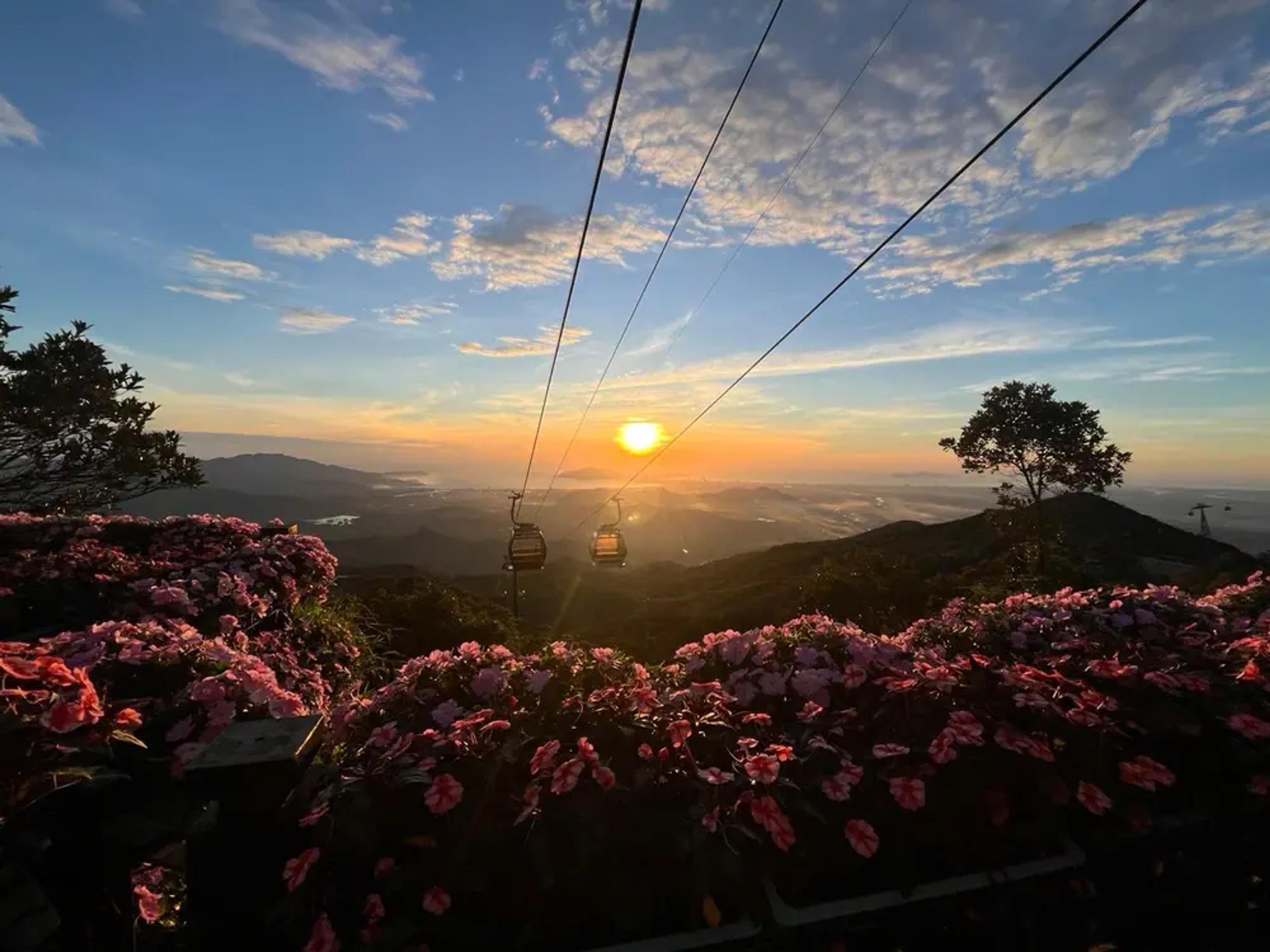 The Ba Na Hills cable car crossing the forested valley in low sun