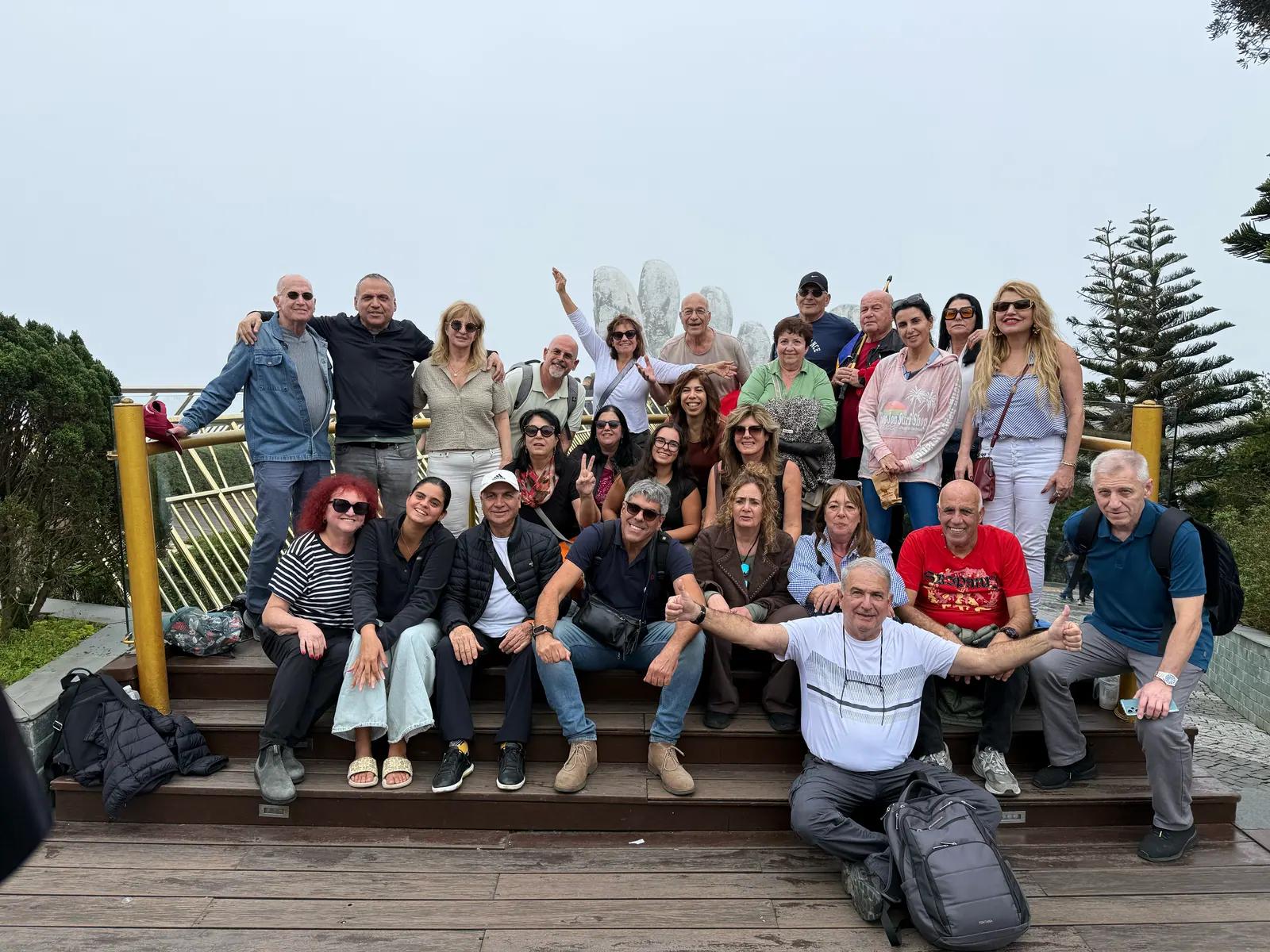 A group of guests on the Golden Bridge at Ba Na Hills