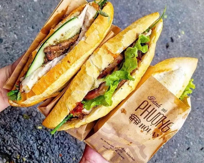 Two banh mi from Banh Mi Phuong in Hoi An, half out of the shop's paper bag