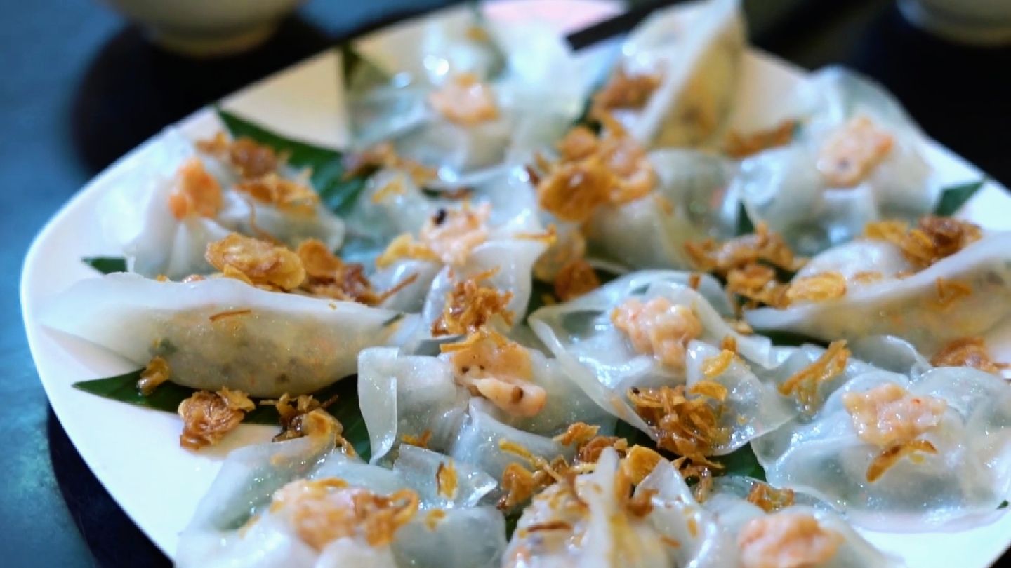 A plate of white rose dumplings topped with fried shallots at White Rose Restaurant in Hoi An
