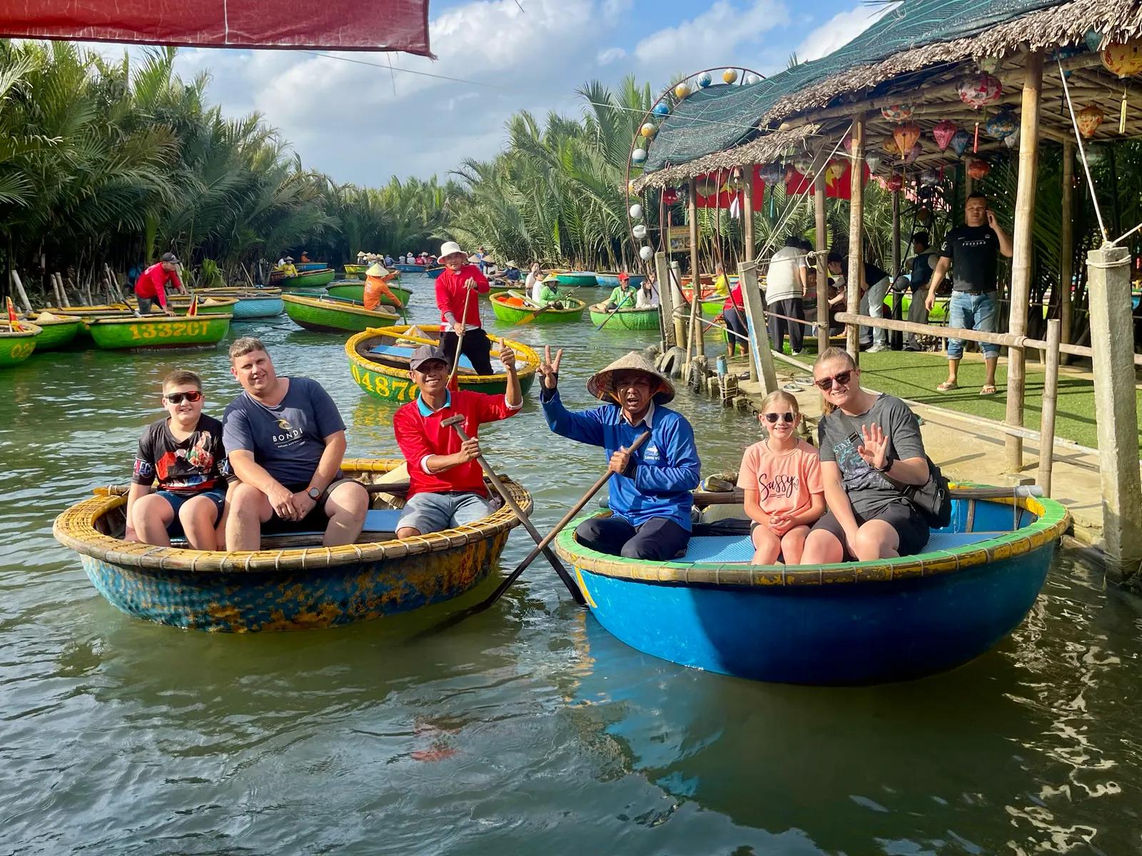 Guests in round bamboo basket boats on the river at Hoi An