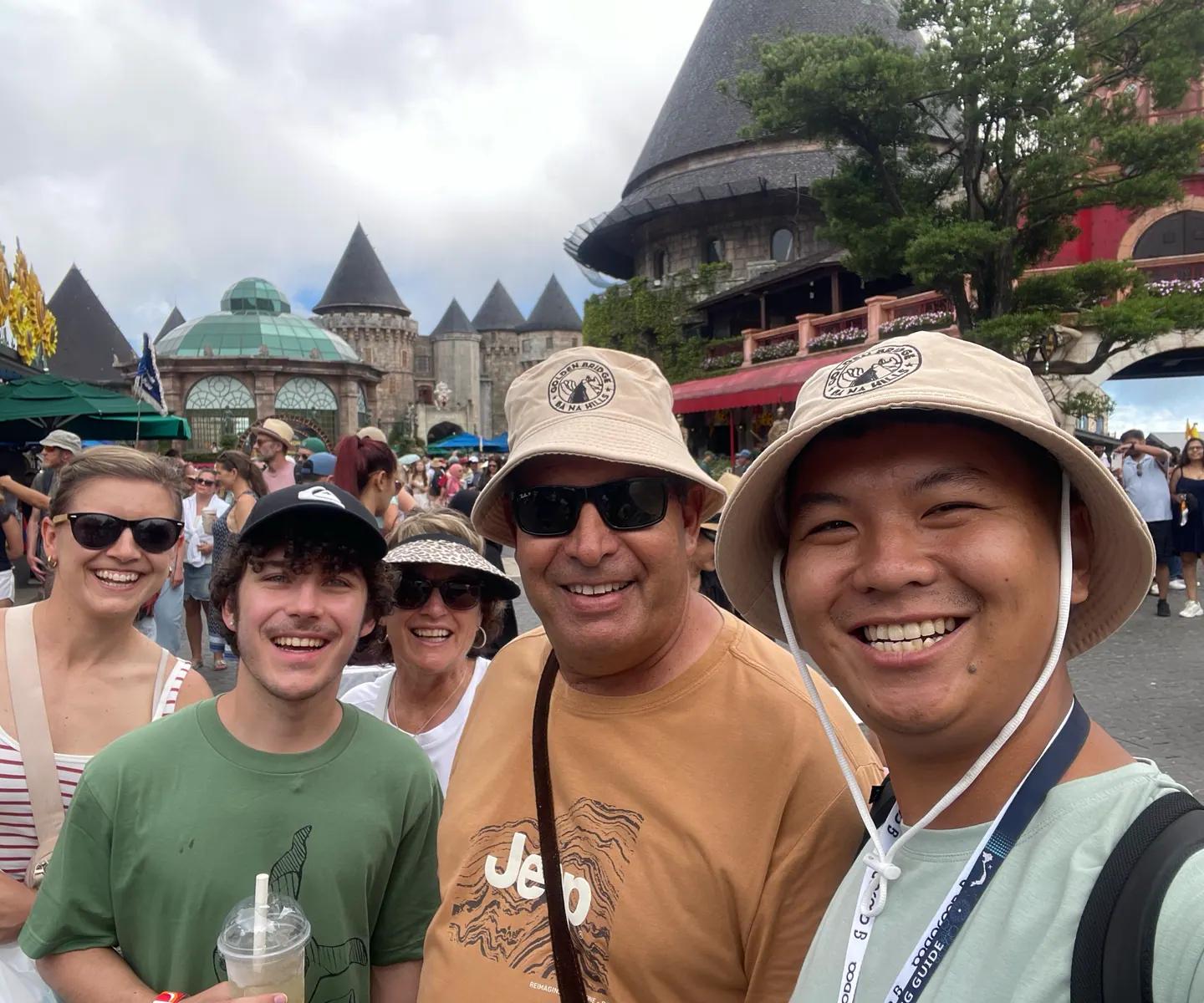 Tom with a family in front of the French Village at Ba Na Hills