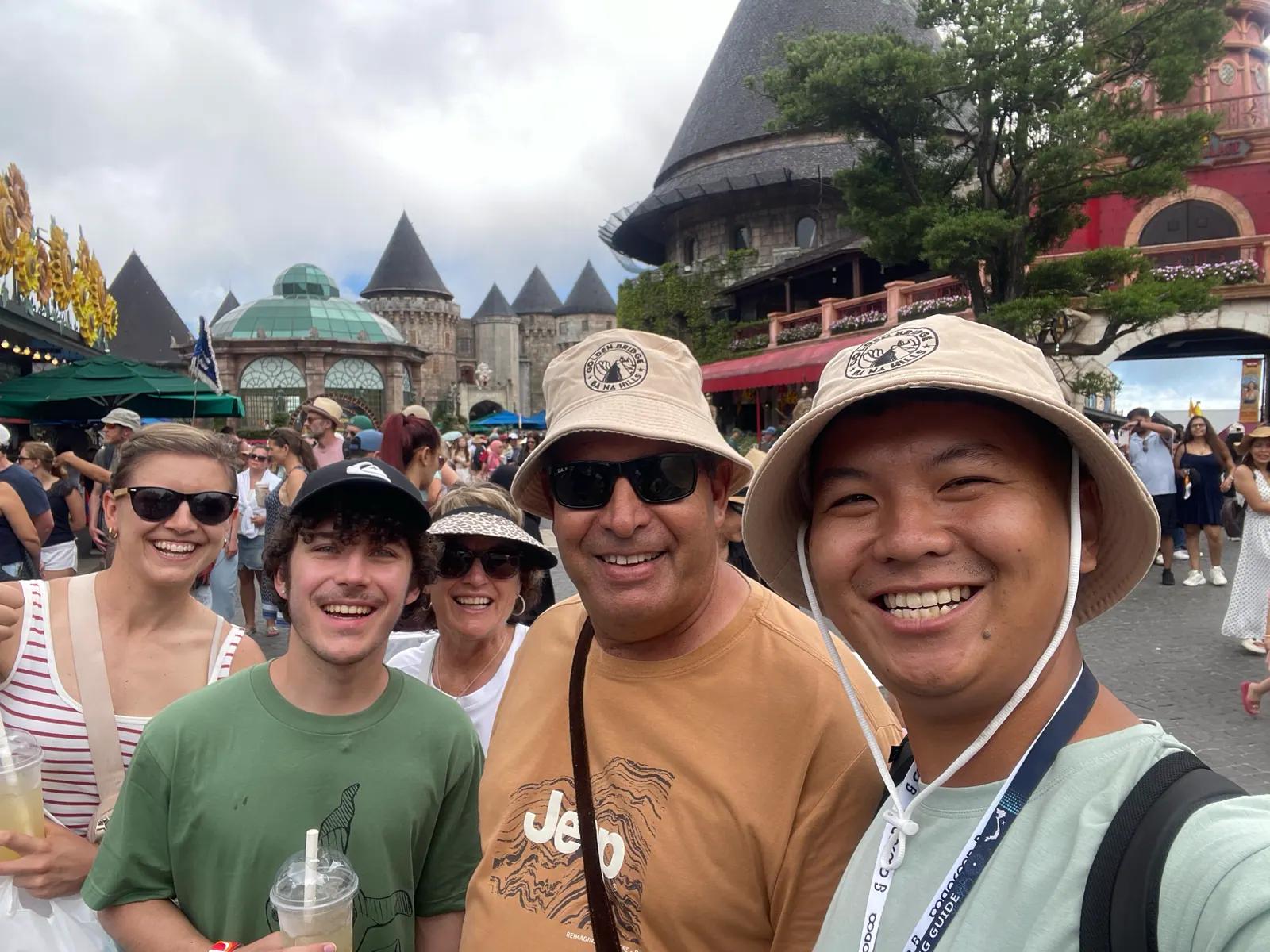 Tom with a family in front of the French Village at Ba Na Hills