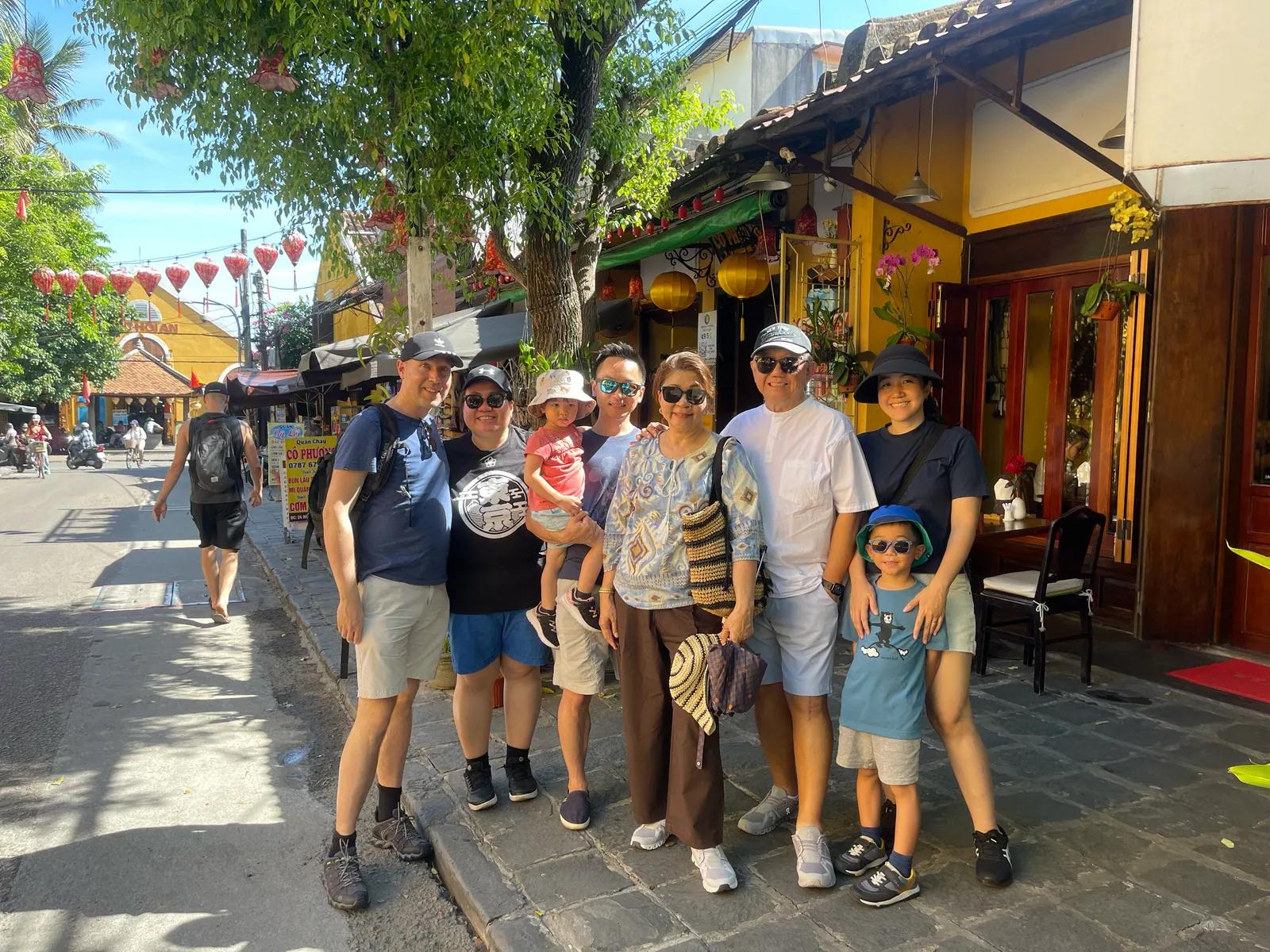 A family on the walking tour outside a tailor shop in the Ancient Town