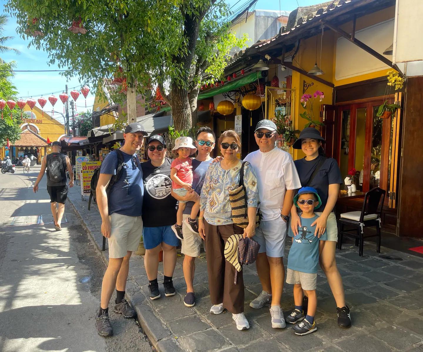 A family on the walking tour outside a tailor shop in the Ancient Town