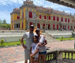 A family in front of the restored Kien Trung Palace in the Hue Imperial Citadel
