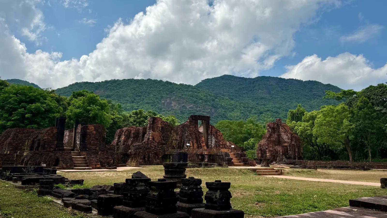 The My Son temple groups standing in the valley with forested mountains behind them