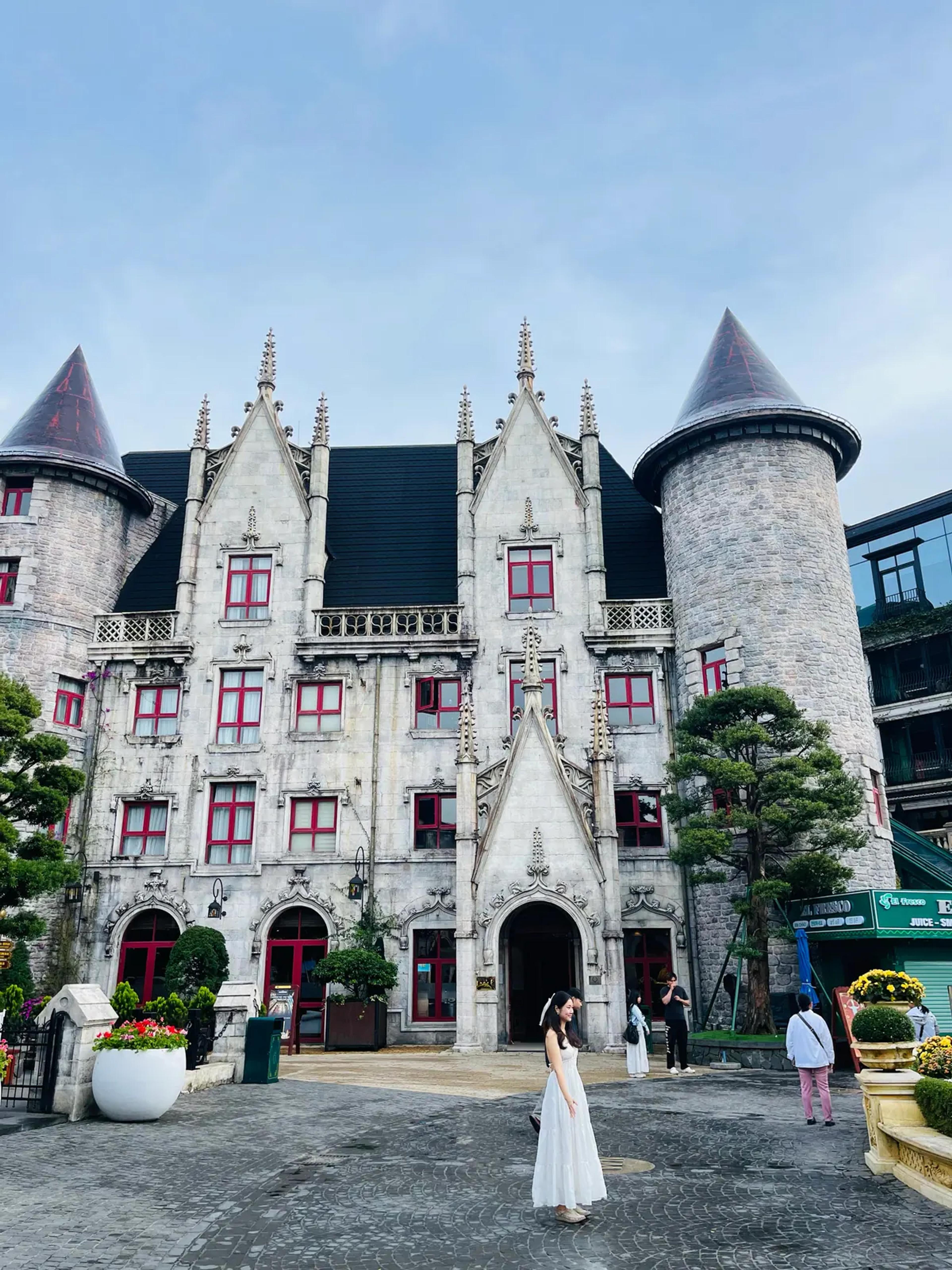 The white castle-style building with pointed towers in the French Village at Ba Na Hills