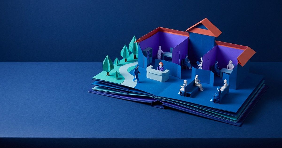 Pop-up book opening into a complete paper clinic with reception, rooms and garden: guide to practice management