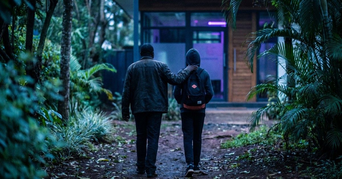 Parent and teenager seen from behind walking together to a Nairobi clinic: guardian consent for minors