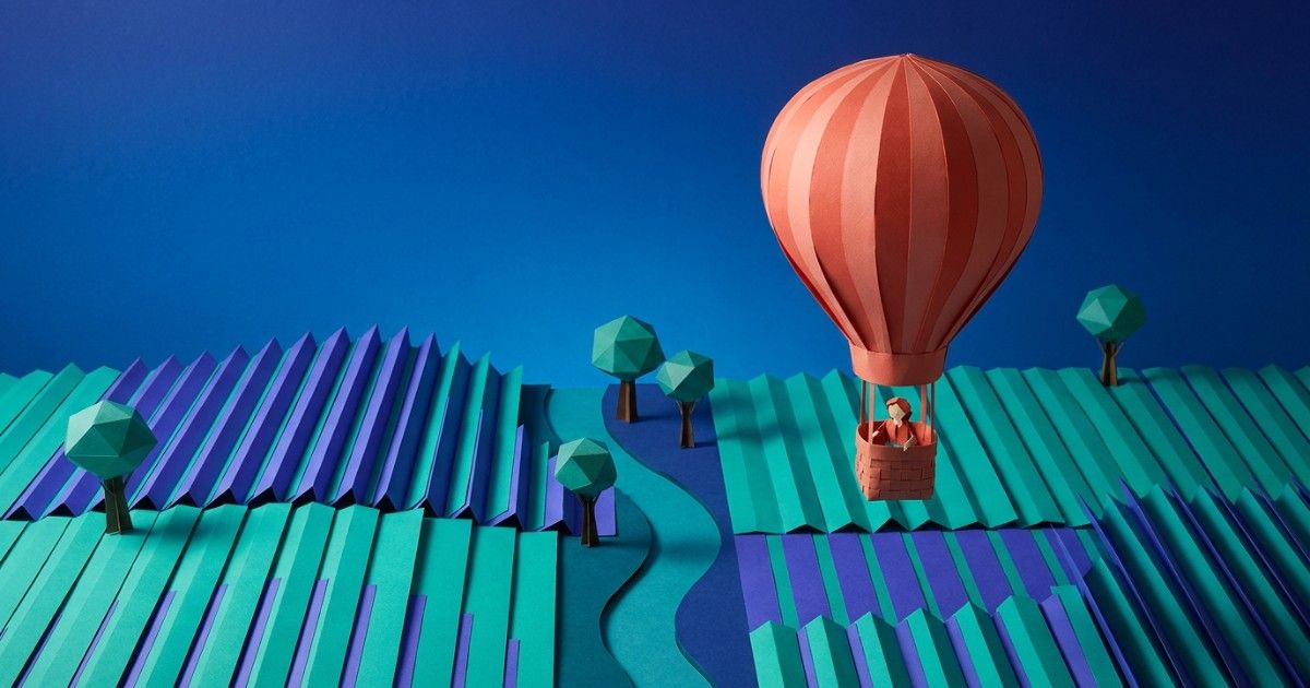 Origami hot-air balloon above folded paper fields: the big-picture view in mental health reports for executives