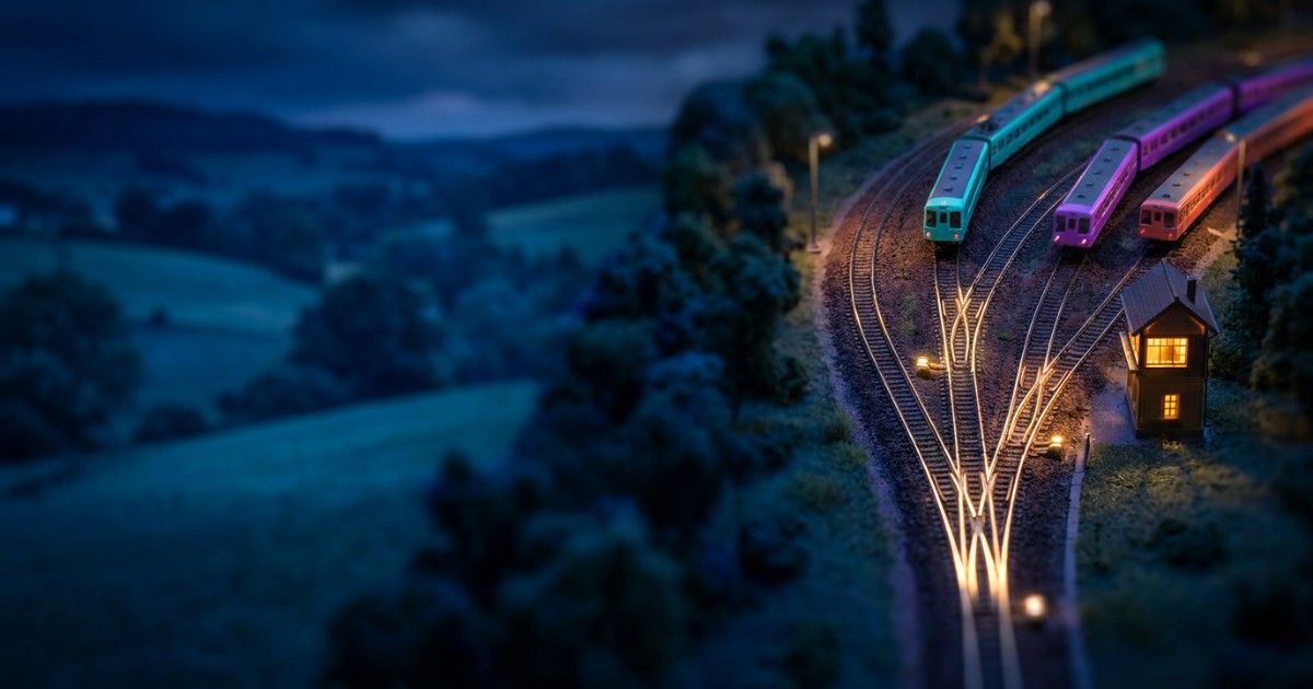 Miniature railway junction where coloured trains merge smoothly onto one line: EMR integration and interoperability
