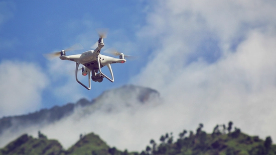 Surveillance drone flying over a fire