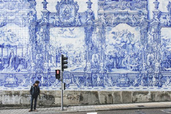 image of a person standing at a street light in Porto, Portugal