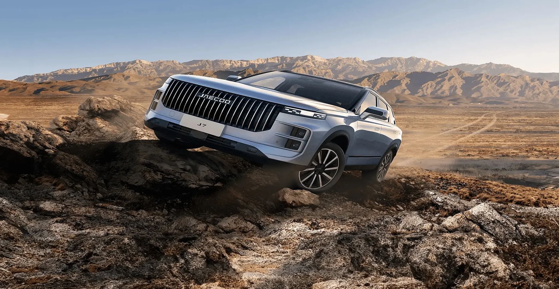A grey JAECOO SUV driving along gravel
